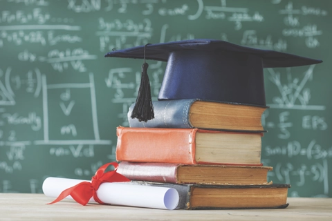 Graduation cap on top of books