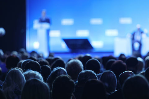 crowd viewing a conference presentation 