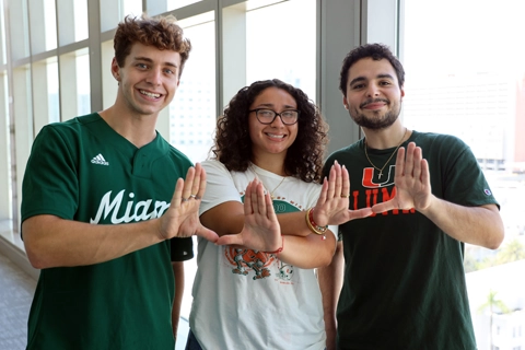 Students doing the U sign at orientation