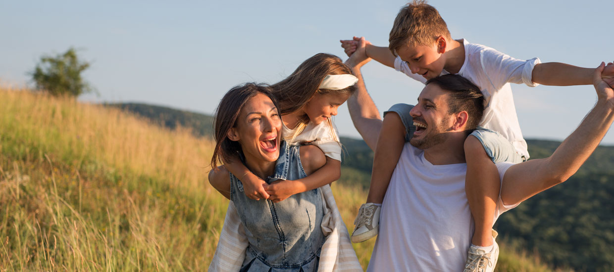 Family outdoors smiling and happy 