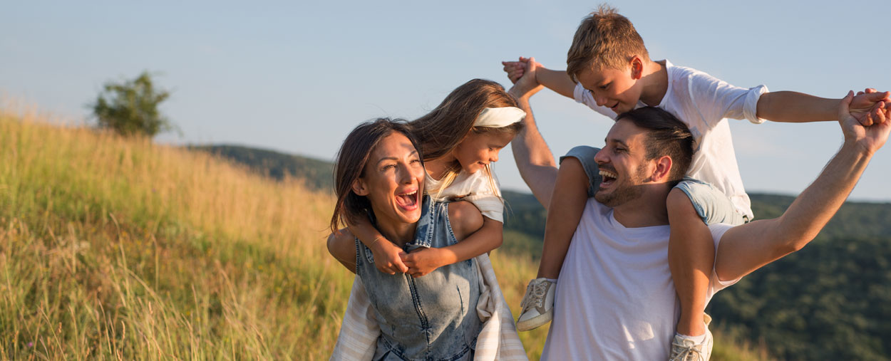 Family outdoors smiling and happy 