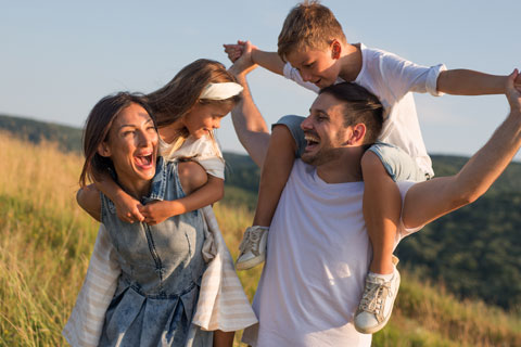 Family outdoors smiling and happy 