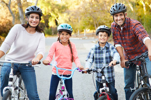 Family smiling and riding bicycles 