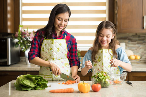 Mother and daughter cooking in kitchen