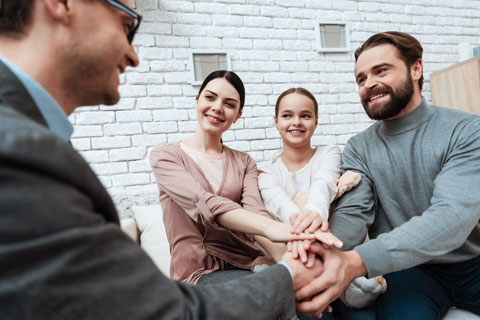 A person shakes hands with family