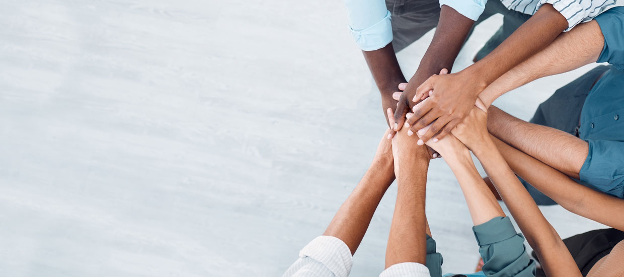 View from above of diverse group of hands united