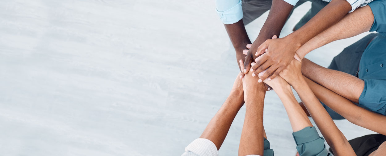 View from above of diverse group of hands united