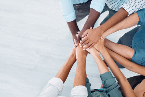 View from above of diverse group of hands united