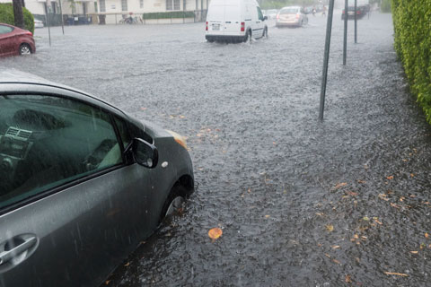 vehicles in the street flooded with rain