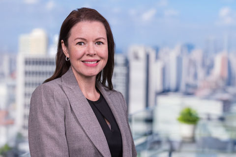Portrait of Kathryn McCollister with a blur skyline background