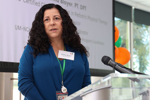 Martha Bloyer standing by podium