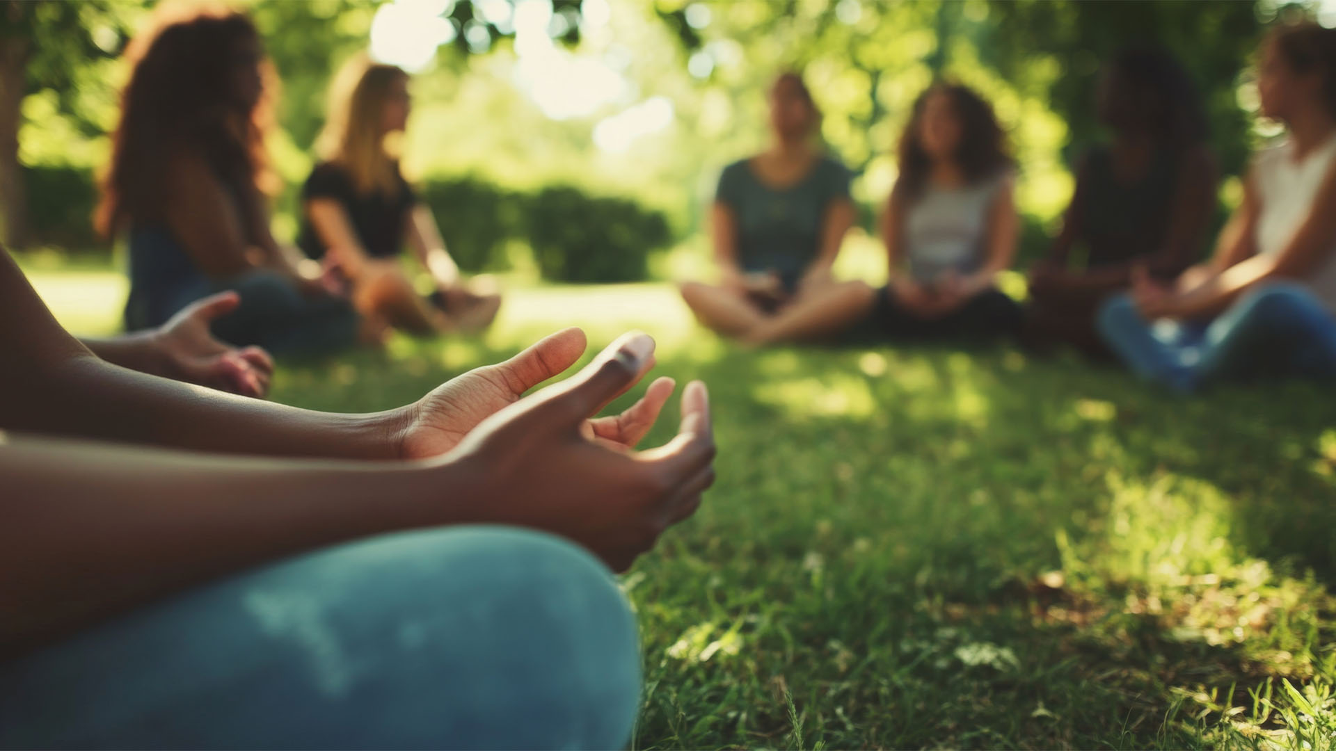 people sitting in a circle on grass