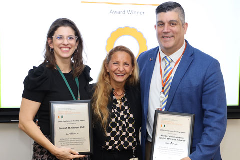 Dr. Caban-Martinez standing with teaching award recipients Dr. St. George and Dr. Horigian