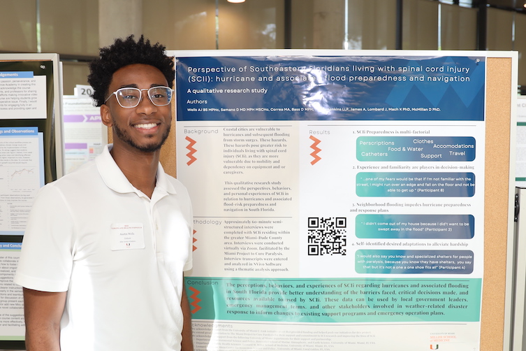 Student Austin Wells in Front of Poster at the Climate and Health Symposium