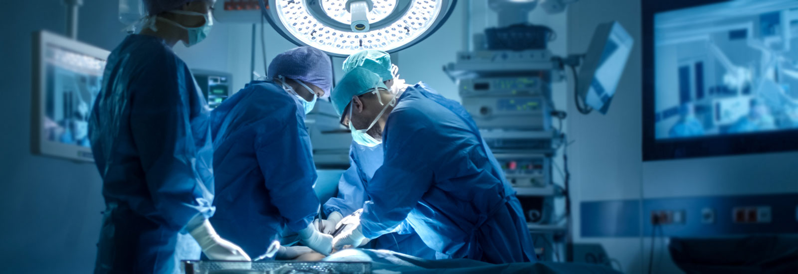 Medial doctors conducting surgical procedure