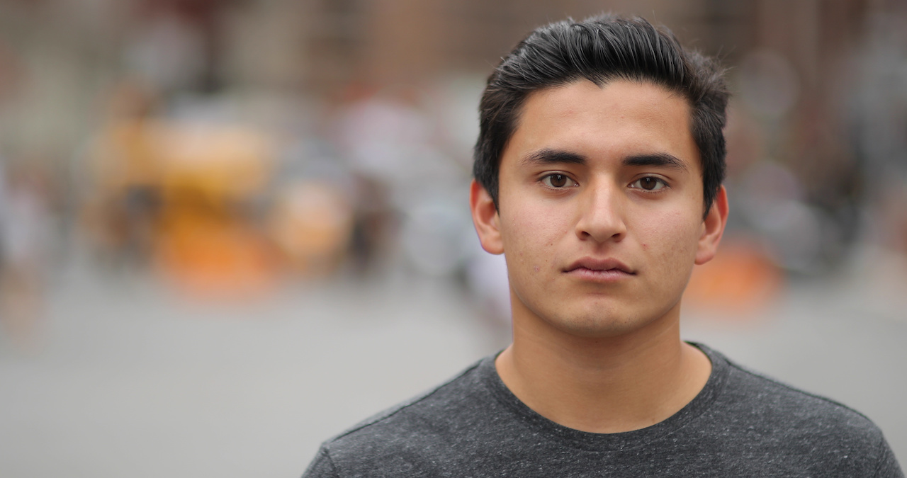 Young latino man in city face portrait serious jpeg
